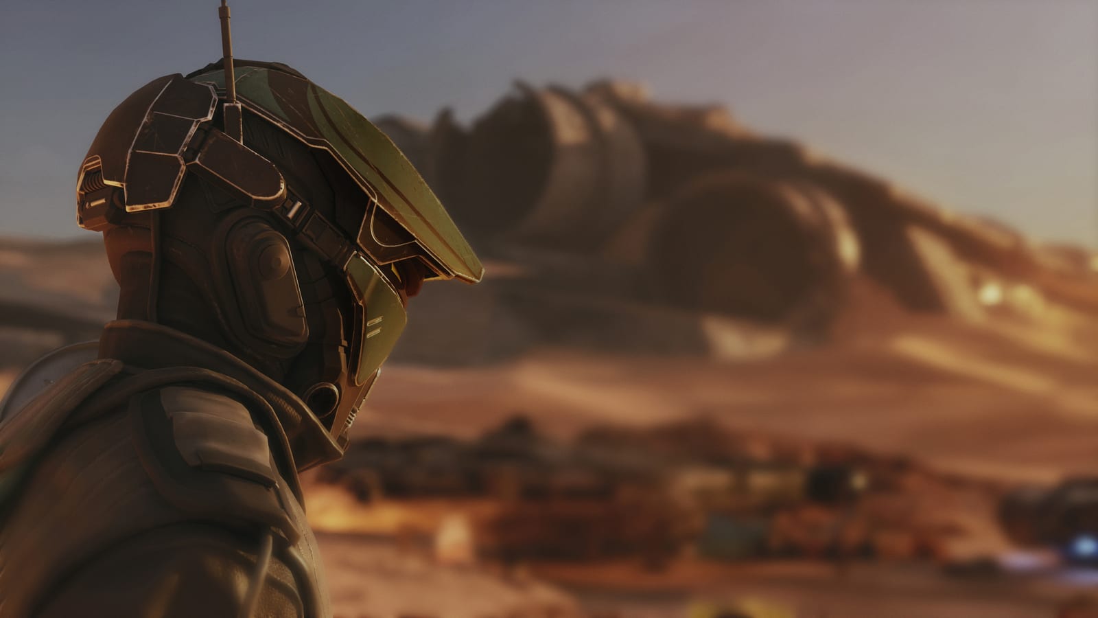 A helmeted racer looking out over a desert settlement